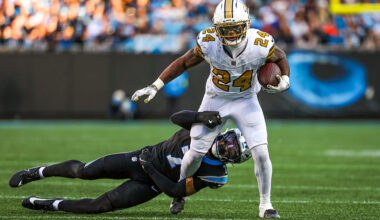 CHARLOTTE, NORTH CAROLINA - NOVEMBER 09: Devin Neal #24 of the New Orleans Saints attempts to break a tackle by Tre'von Moehrig #7 of the Carolina Panthers during the second half of an NFL game at Bank of America Stadium on November 09, 2025 in Charlotte, North Carolina. (Photo by David Jensen/Getty Images)