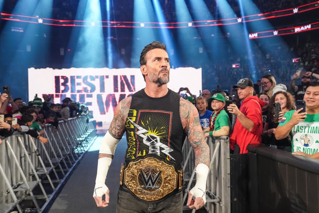 CM Punk wearing the WWE Championship at Monday Night Raw.