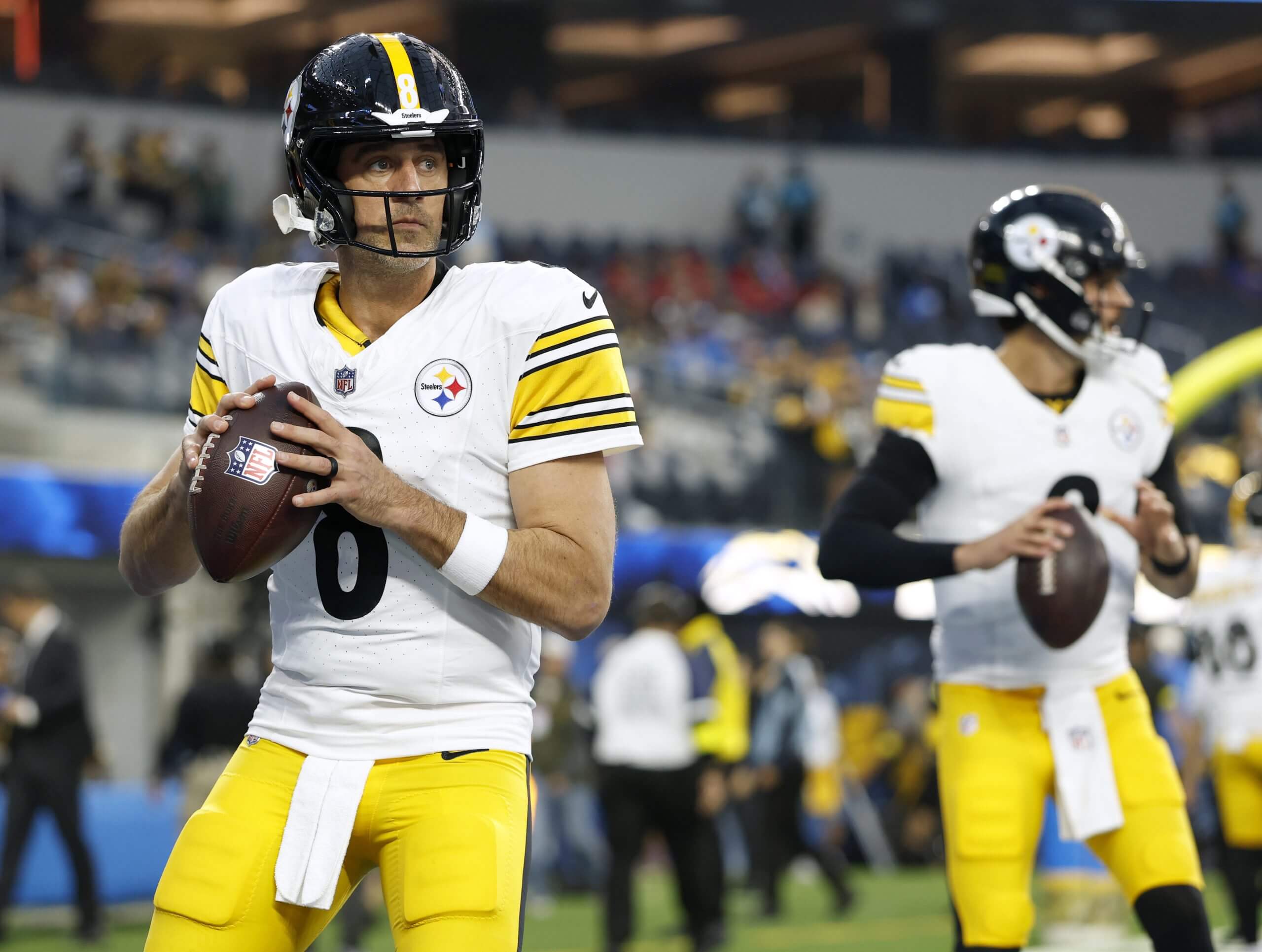 Aaron Rodgers, left, and Mason Rudolph warm up before a game.