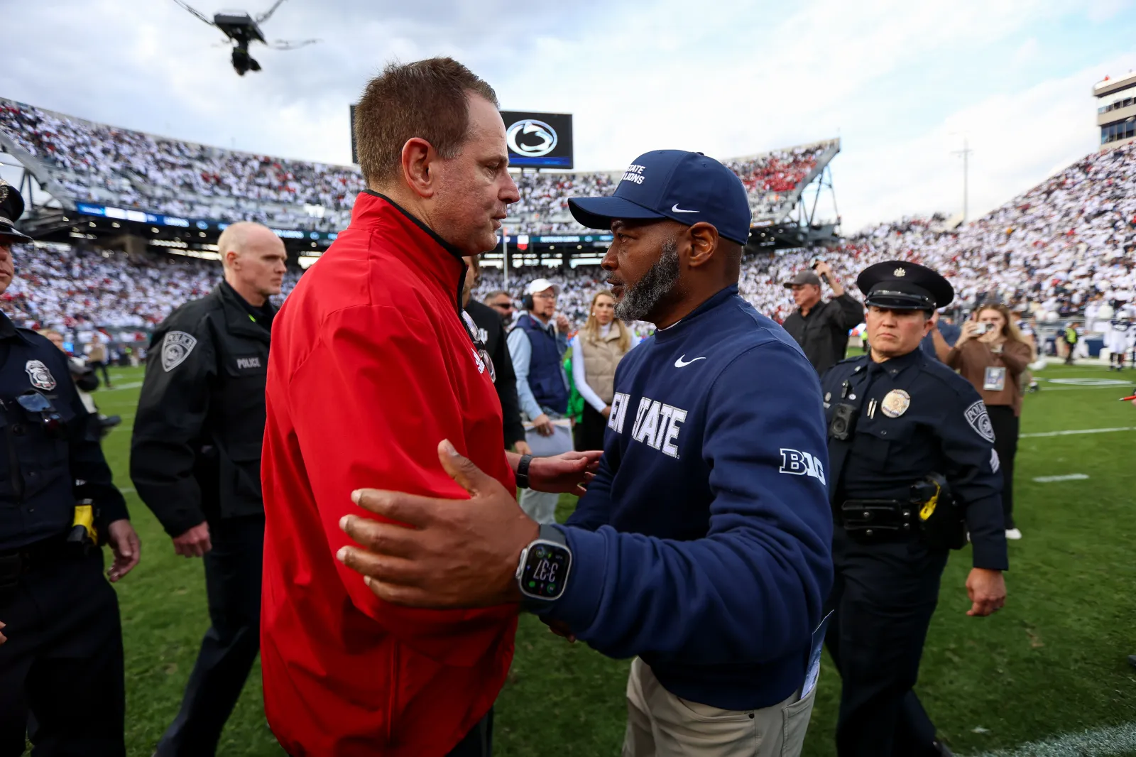 College football head coach Curt Cignetti of the Indiana Hoosiers hand shakes with Interim Head Coach Terry Smith of the Penn State Nittany Lions