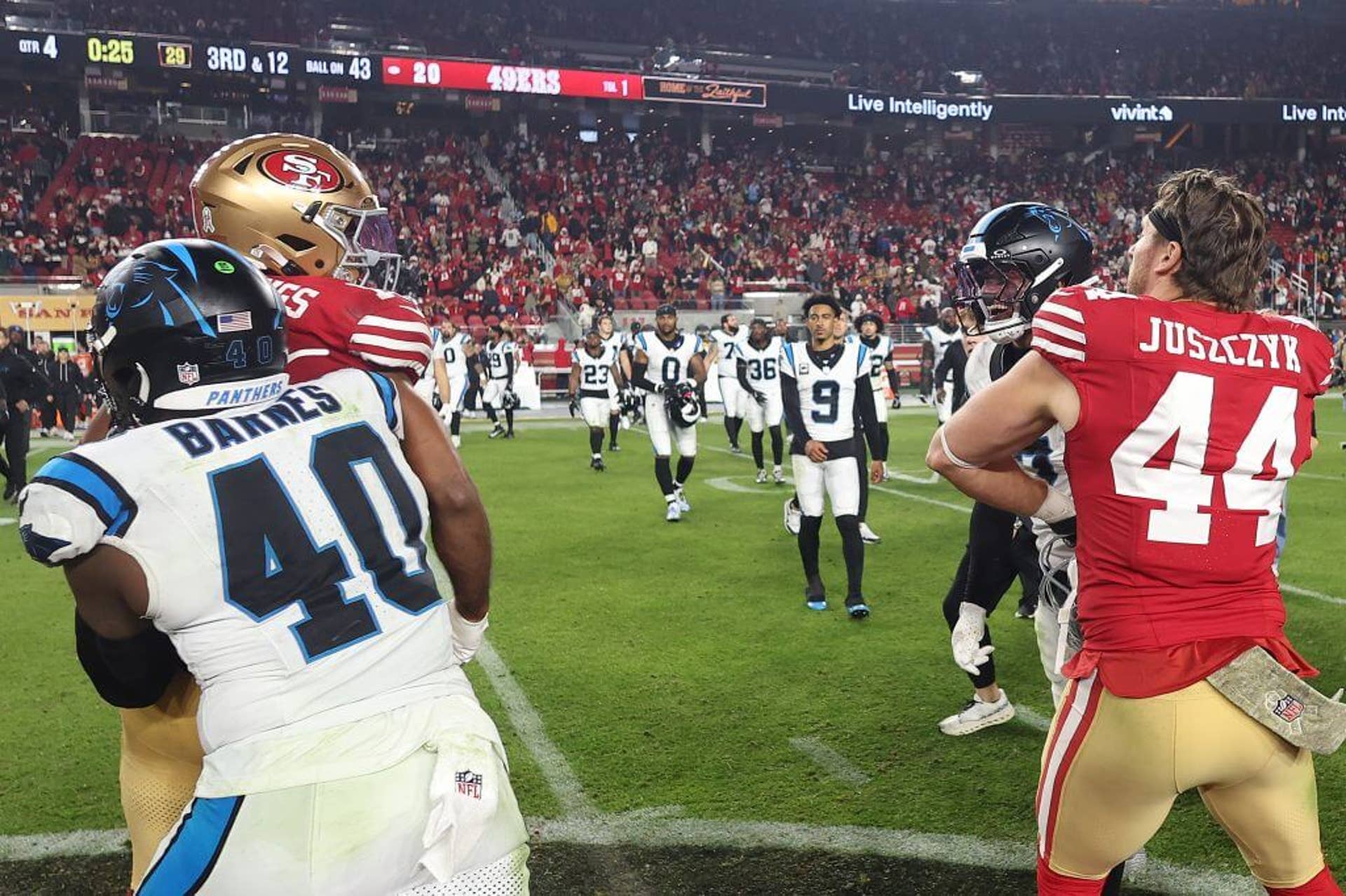Carolina's Krys Barnes holds back San Francisco's Jauan Jennings while Kyle Juszczyk holds back Tre'von Moehrig after the two players got into a postgame altercation.