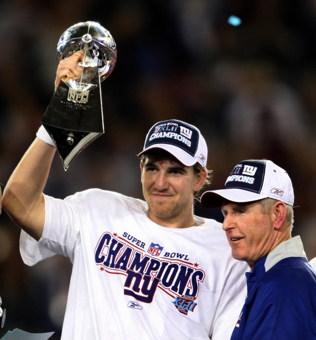 MVP Eli Manning of the New York Giants and coach Tom Coughlin celebrate after defeating the New England Patriots in Super Bowl XLII at the University of Phoenix Stadium in Glendale, Arizona 03 February 2008. The Giants won 17-14. AFP PHOTO/Timothy A. CLARY (Photo by TIMOTHY A. CLARY / AFP) (Photo by TIMOTHY A. CLARY/AFP via Getty Images)