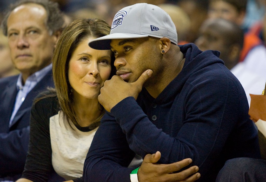 CHARLOTTE, NC - APRIL 26:  Carolina Panthers wide receiver Steve Smith and his wife Angie sit courtside during the NBA basketball game between the Orlando Magic and the Charlotte Bobcats in Game Four of the Eastern Conference Quarterfinals during the 2010 NBA Playoffs at Time Warner Cable Arena on April 26, 2010 in Charlotte, North Carolina. The Magic defeated the Bobcats 99-90 to complete the 4-game sweep. 