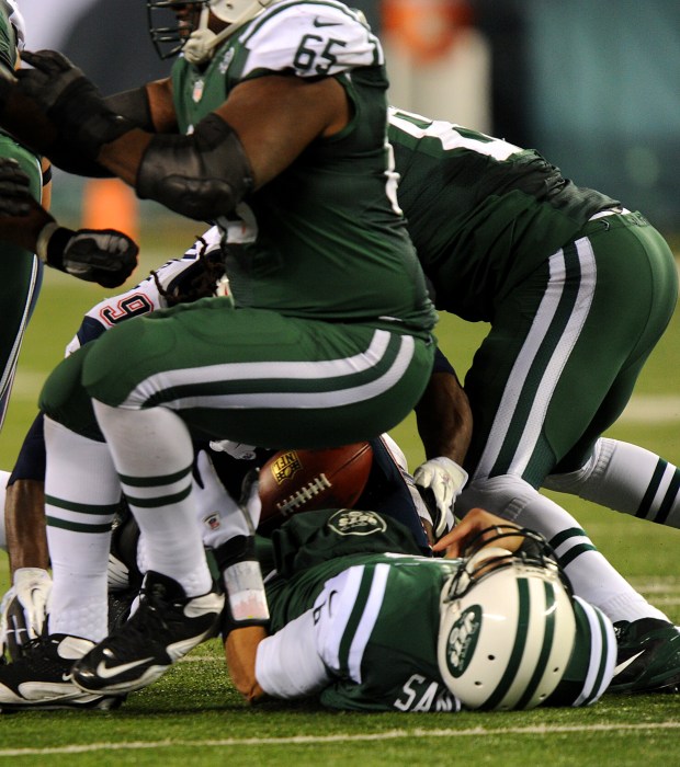 New York Jets quarterback Mark Sanchez fumbles the ball in the first half when the New York Jets played the New England Patriots Thursday, Nov. 22, 2012, at MetLife Stadium in East Rutherford, New Jersey. (Robert Sabo / New York Daily News)