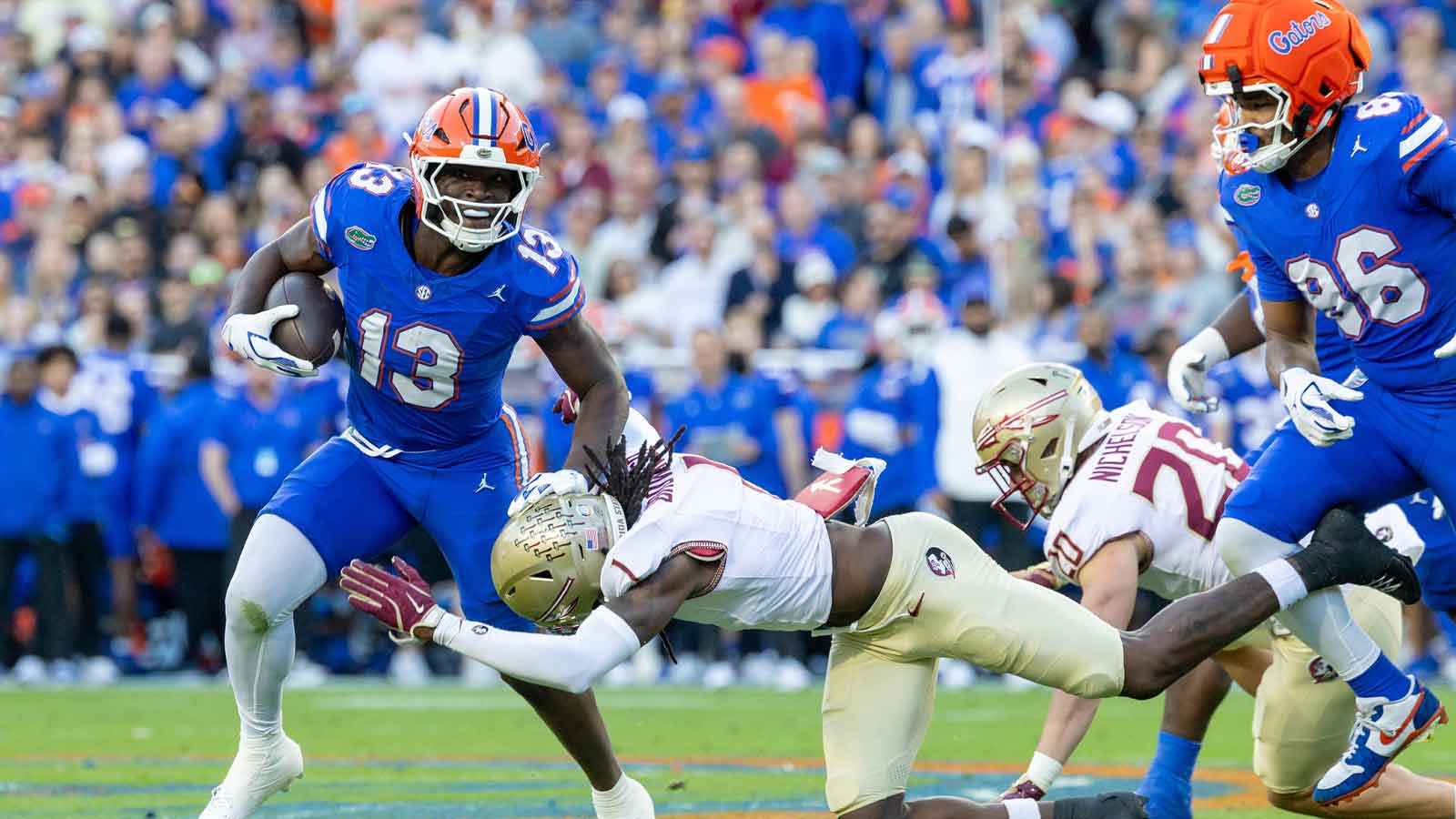 Florida Gators running back Jadan Baugh (13) runs during the first quarter against the Florida State Seminoles at Ben Hill Griffin Stadium.