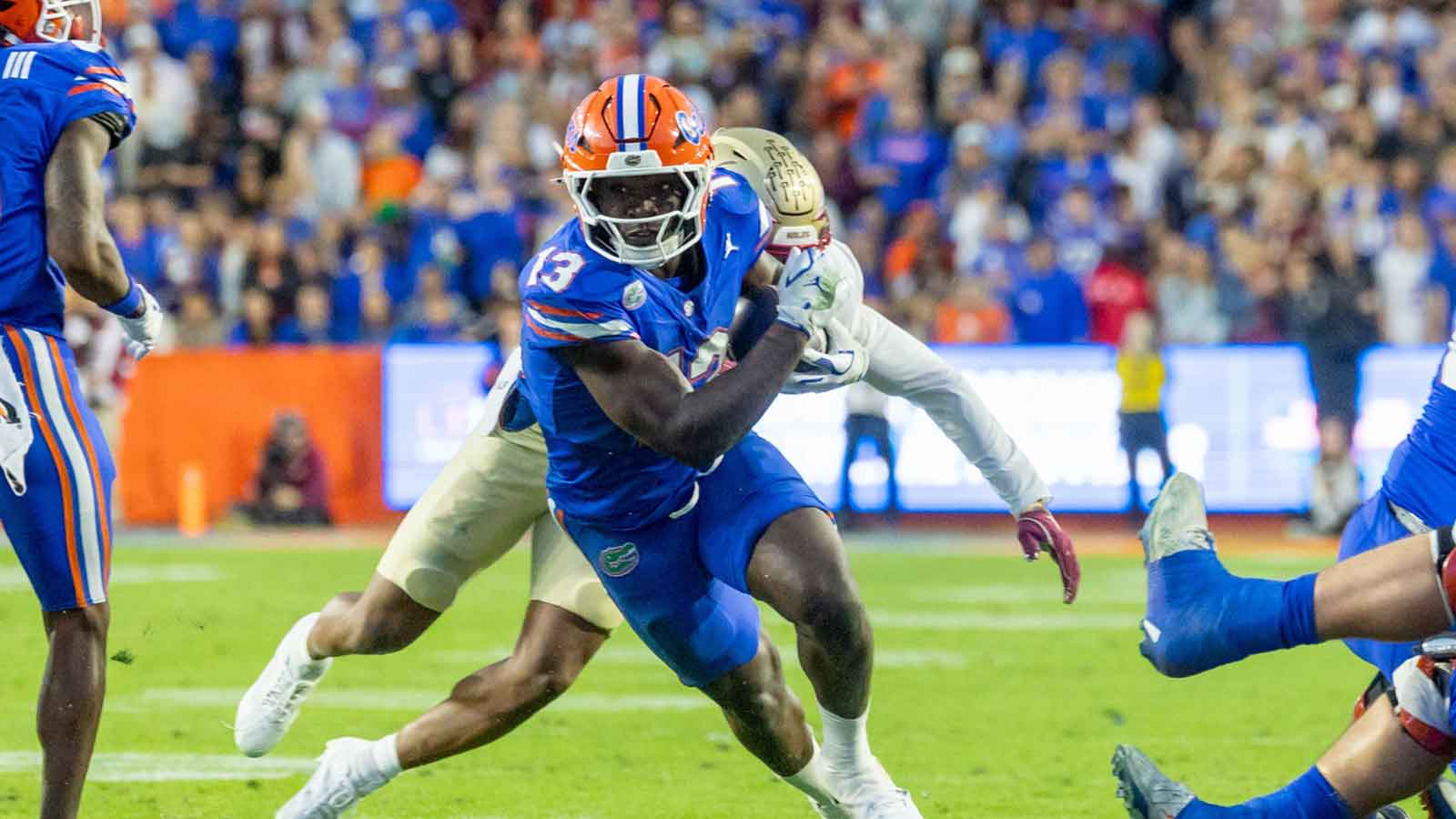 Florida Gators running back Jadan Baugh (13) runs during the first quarter against the Florida State Seminoles at Ben Hill Griffin Stadium.