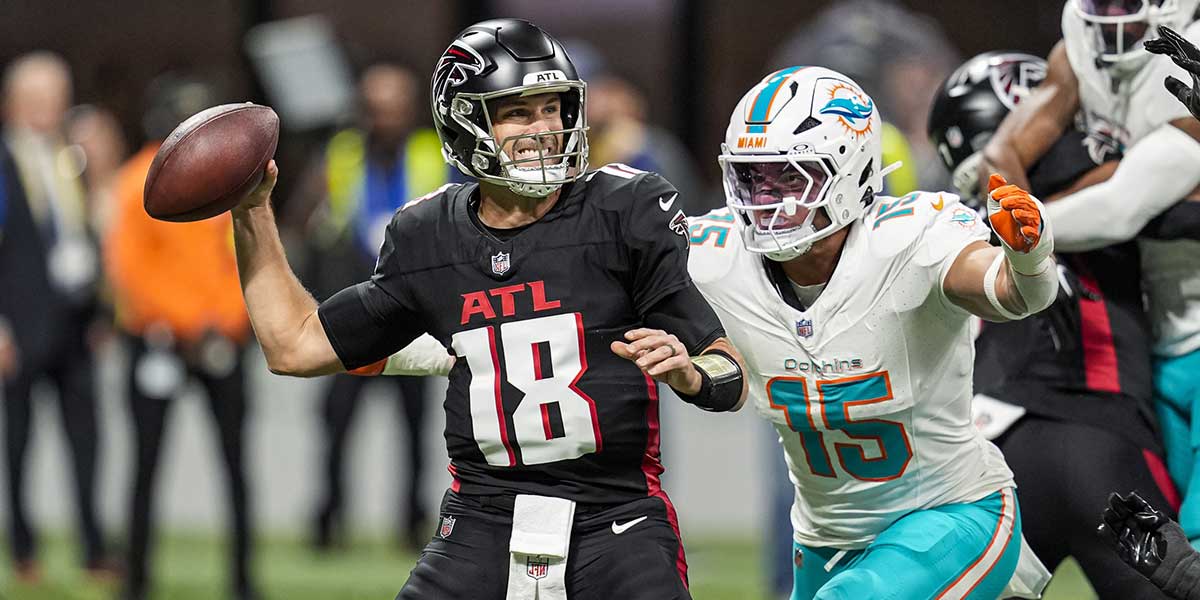 Atlanta Falcons quarterback Kirk Cousins (18) passes under pressure from Miami Dolphins linebacker Jaelan Phillips (15) during the first quarter at Mercedes-Benz Stadium. 