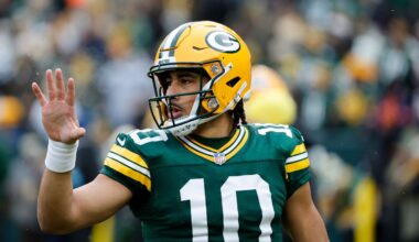 Jordan Love waving towards the crowd at a game, closeup on him.