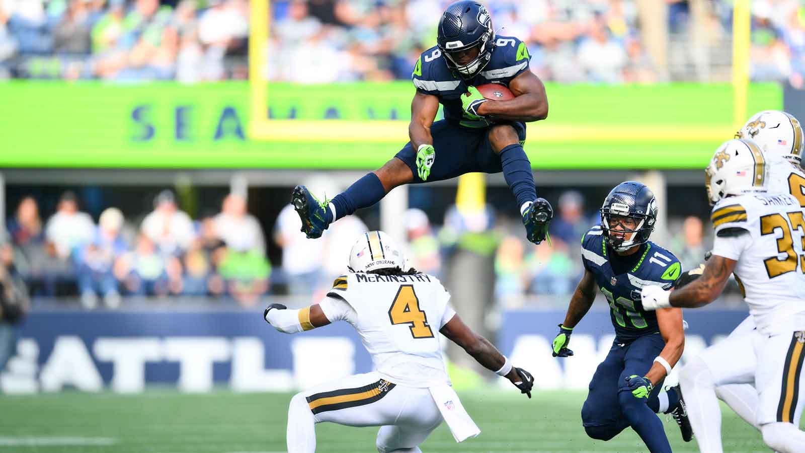 Seattle Seahawks running back Kenneth Walker III (9) hurdles over New Orleans Saints cornerback Kool-Aid McKinstry (4) during the third quarter at Lumen Field.
