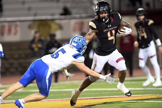 Oaks Christian’s Deshonne Redeaux (4) tries to get by La...