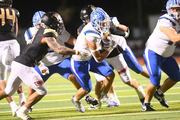 La Habra’s Kevika Mata’Utia- Martinez (4) carries the ball against...