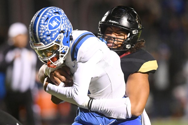 Oaks Christian’s Alifeleti Tuihalamaka (44) tackles La Habra quarterback DJ...