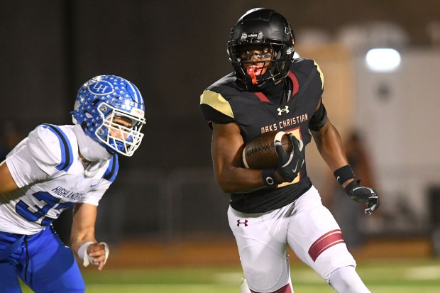 Oaks Christian’s Davon Benjamin (5) gets by La Habra’s Noah...