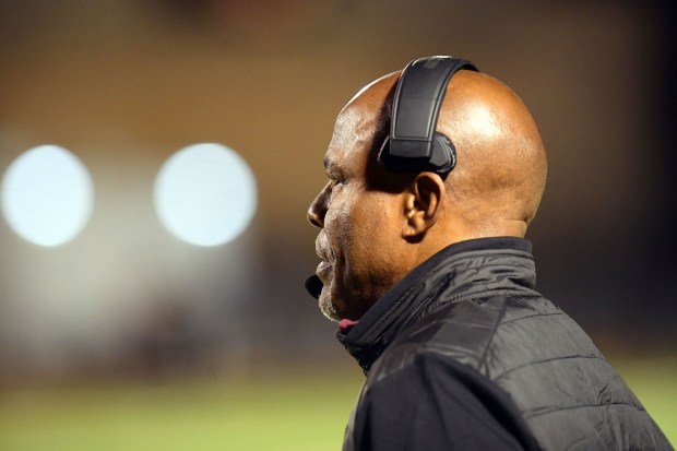 Oaks Christian football coach Charles Collins looks on as they...