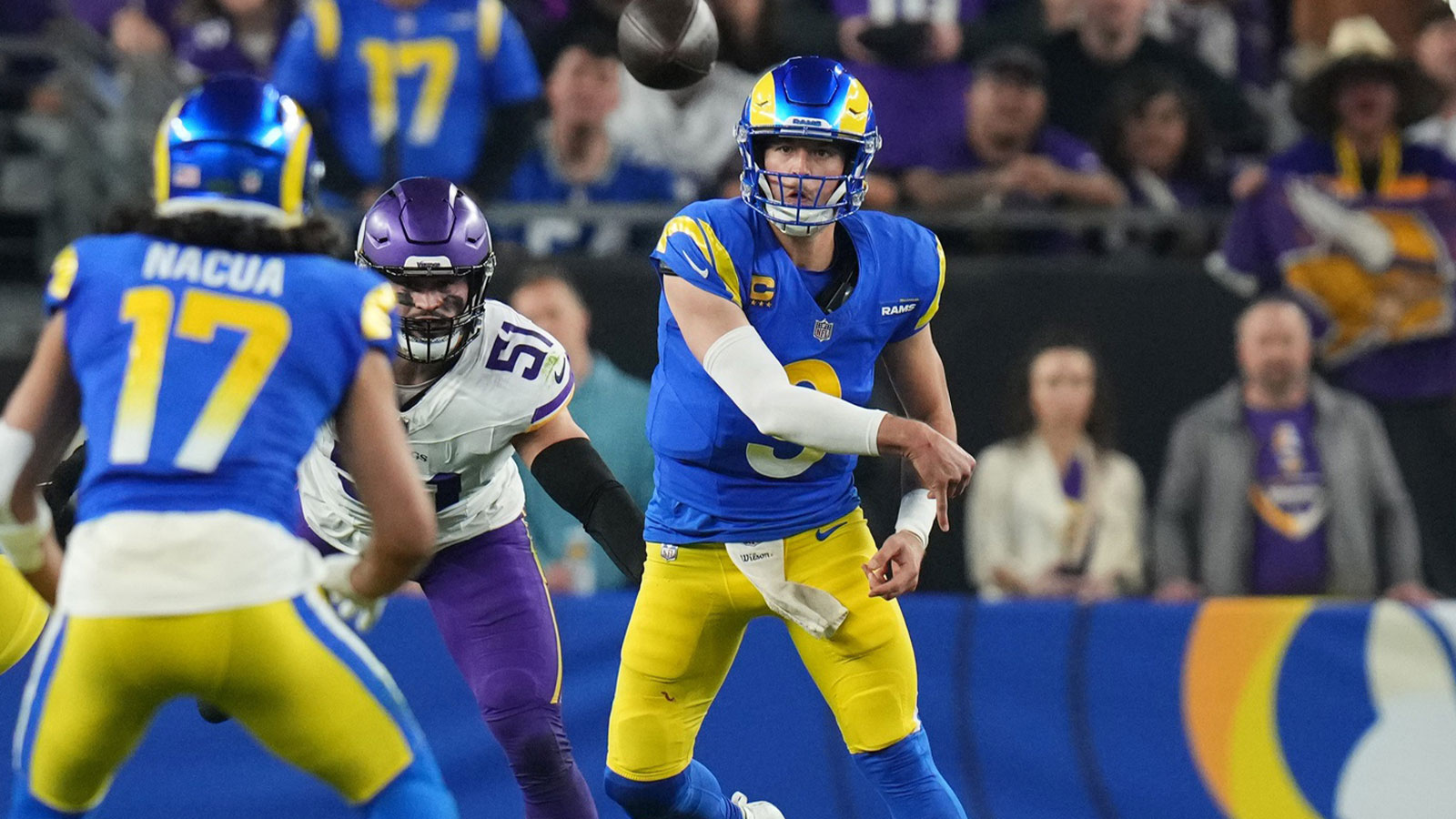 Los Angeles Rams quarterback Matthew Stafford (9) throws the ball to receiver Puka Nacua (17) against the Minnesota Vikings during their playoff game at State Farm Stadium.