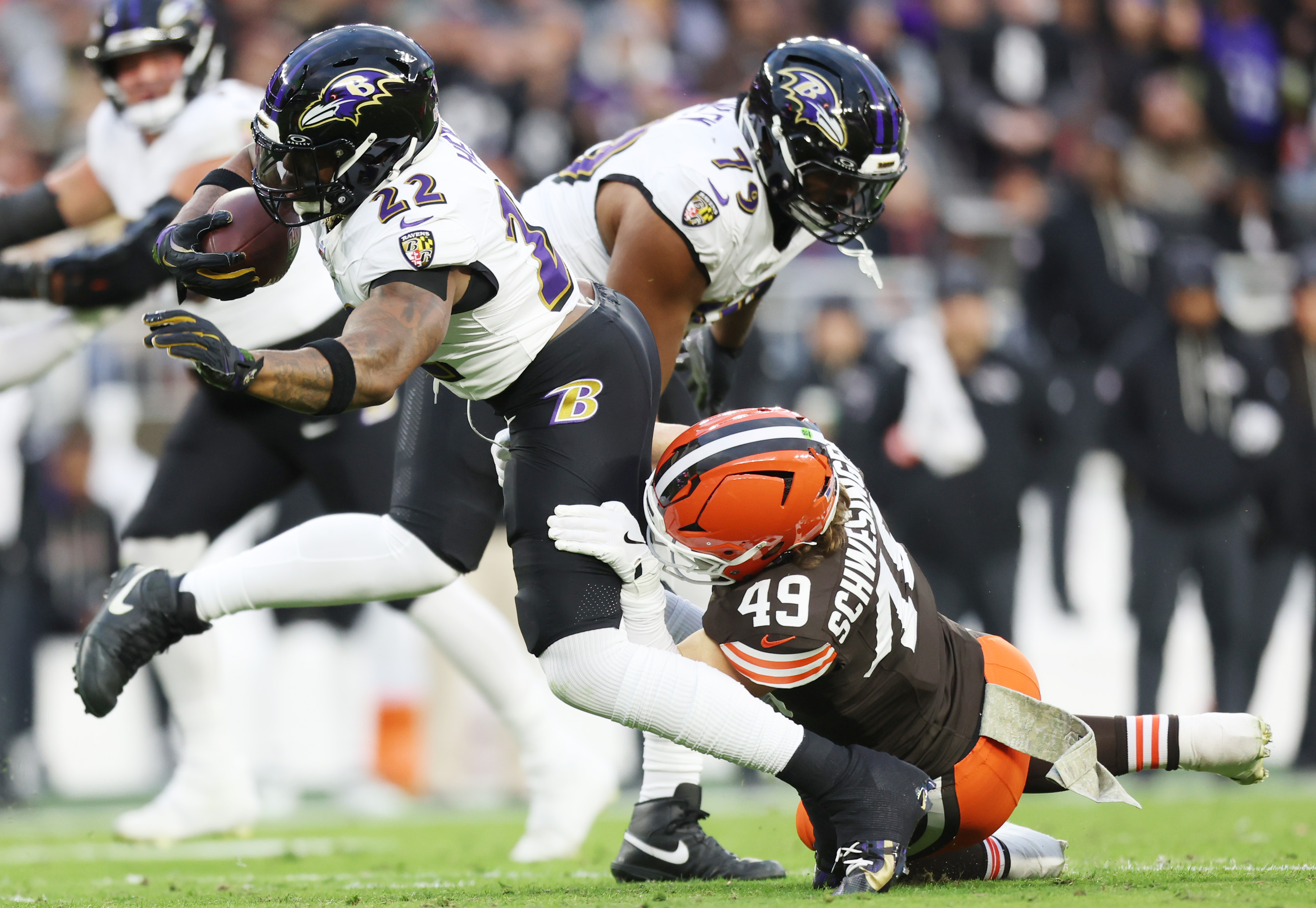 Baltimore Ravens running back Derrick Henry gains seven yards on a rush in the first quarter as he is tackled by Cleveland Browns linebacker Carson Schwesinger at Huntington Bank Field.