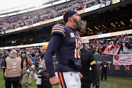 Chicago Bears quarterback Caleb Williams (18) celebrates as he leaves the field after an NFL...