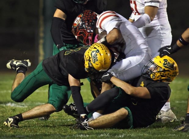Segerstrom's (21), Ayden Morales, left, is dragged down by Brea Olinda Defenders. The game was held at Brea Olinda High School in the city of Brea on Friday, Oct. 24, 2025...(Photos by Karen Tapia, Contributing Photographer)