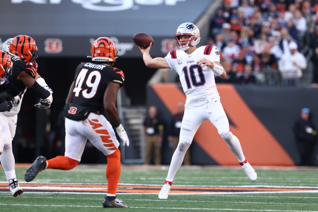 New England Patriots quarterback Drake Maye (10) makes an off-balance throw during an NFL game against the Cincinnati Bengals on Sunday in Cincinnati, OH (AP Photo/Peter Joneleit)