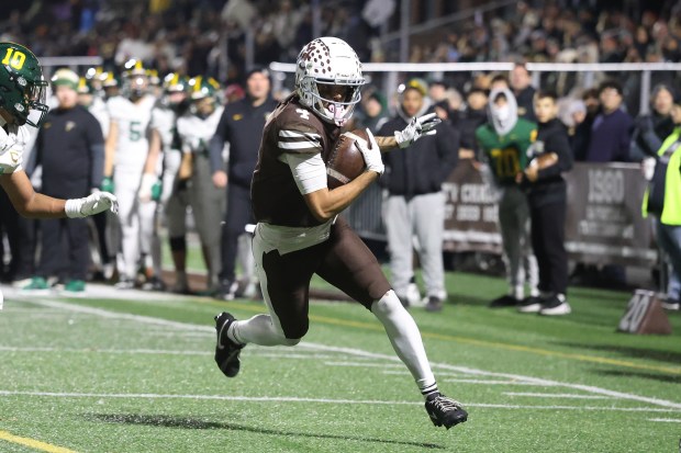 Mt. Carmel's Quentin Burrell (4) scores on a catch and run against Fremd in the Class 8A state semifinal on Nov. 22, 2025. (Gary Middendorf/for the Daily Southtown)