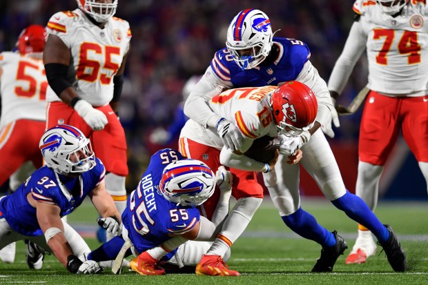 Buffalo Bills defensive ends Greg Rousseau, right, Michael Hoecht (55) and Joey Bosa (97) sack Kansas City Chiefs quarterback Patrick Mahomes (15) during the second half of an NFL football game Sunday, Nov. 2, 2025, in Orchard Park, N.Y. (AP Photo/Adrian Kraus)
