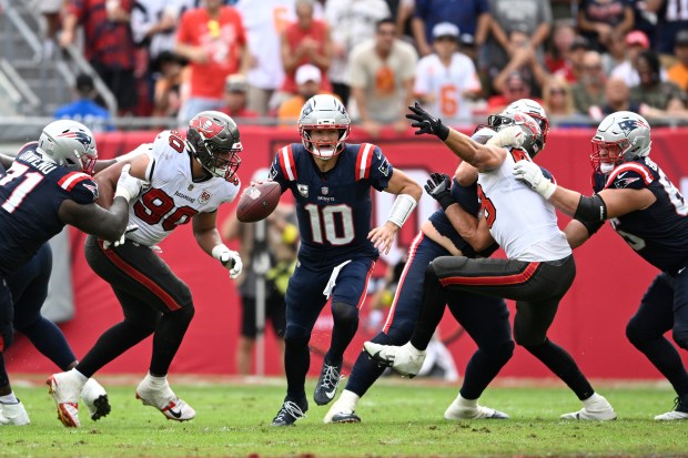 New England Patriots quarterback Drake Maye (10) scrambles for yardage against the Tampa Bay Buccaneers during the first half of an NFL football game, Sunday, Nov. 9, 2025, in Tampa, Fla. (AP Photo/Phelan M. Ebenhack)