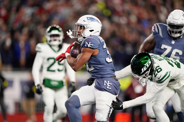 New England Patriots running back TreVeyon Henderson carries the ball for a touchdown during the first half of an NFL football game against the New York Jets, Thursday, Nov. 13, 2025, in Foxborough, Mass. (AP Photo/Robert F. Bukaty)