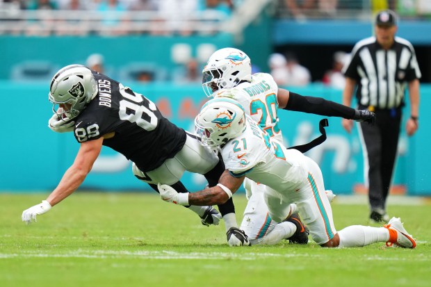 Jordan Poyer #21 of the Miami Dolphins tackles Brock Bowers #89 of the Las Vegas Raiders in the fourth quarter at Hard Rock Stadium on Nov. 17, 2024 in Miami Gardens, Florida. (Photo by Rich Storry/Getty Images)