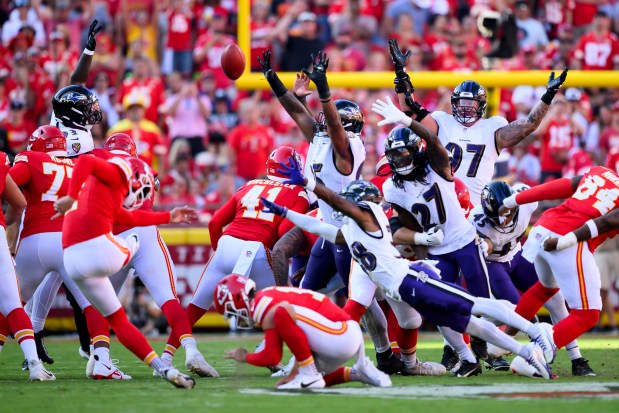 Kansas City Chiefs kicker Harrison Butker, left, misses a field goal attempt against the Baltimore Ravens during the first half of an NFL football game, Sunday, Sept. 28, 2025 in Kansas City, Mo. (AP Photo/Reed Hoffmann)