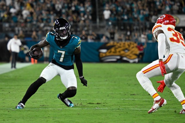 Jacksonville Jaguars wide receiver Brian Thomas Jr. (7) runs after catching a pass in front of Kansas City Chiefs cornerback Jaylen Watson (35) during the first half of an NFL football game, Monday, Oct. 6, 2025, in Jacksonville, Fla. (AP Photo/Phelan M. Ebenhack)