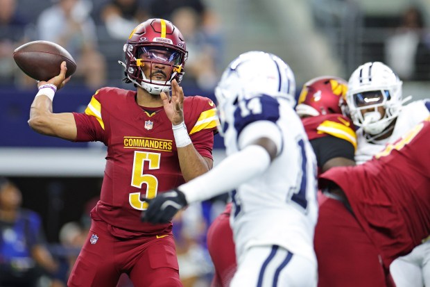 Jayden Daniels #5 of the Washington Commanders looks to pass during the first half against the Dallas Cowboys  at AT&T Stadium on Oct. 19, 2025 in Arlington, Texas. (Photo by Stacy Revere/Getty Images)