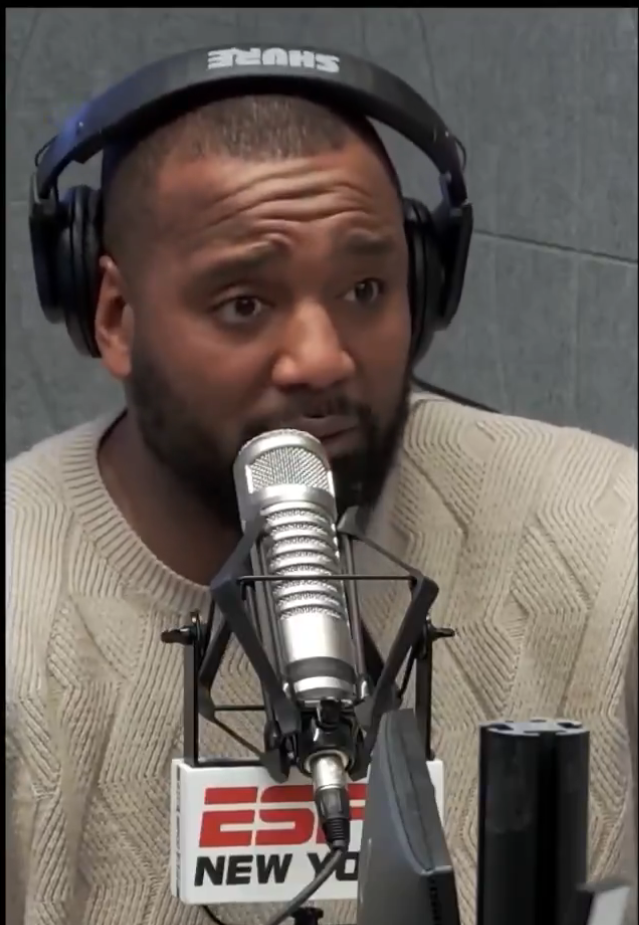 A man with headphones and a beard sits in front of a microphone with the ESPN New York logo.