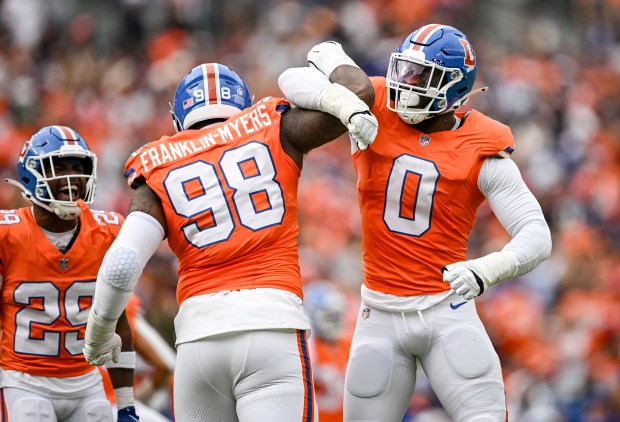 John Franklin-Myers (98) of the Denver Broncos celebrates sacking Dak Prescott (4) of the Dallas Cowboys with teammate Jonathon Cooper (0) during the first quarter at Empower Field at Mile High in Denver on Sunday, Oct. 26, 2025. (Photo by AAron Ontiveroz/The Denver Post)