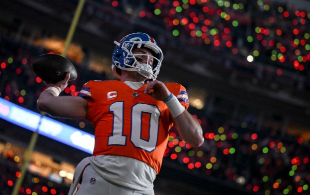 Bo Nix (10) of the Denver Broncos primes the hose...