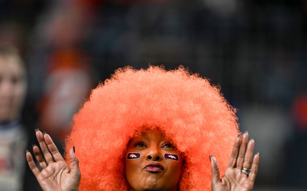A Denver Broncos fan cheers during the first quarter against...