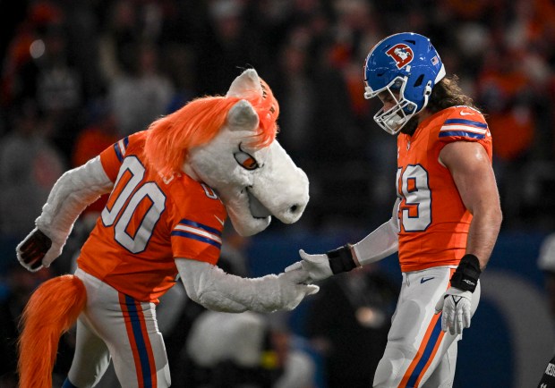 Alex Singleton (49) of the Denver Broncos shakes hands with Miles before the game against the Las Vegas Raiders at Empower Field at Mile High on Thursday, Nov. 6, 2025. (Photo by AAron Ontiveroz/The Denver Post)