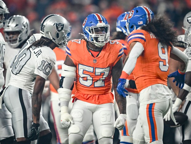 Dre Greenlaw (57) of the Denver Broncos celebrates teammate Talanoa...