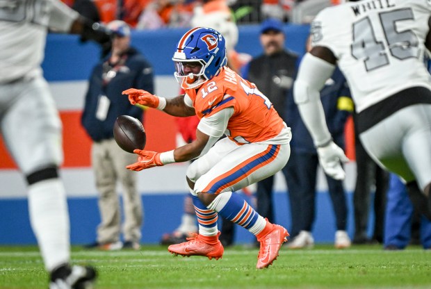 RJ Harvey (12) of the Denver Broncos bobbles a pass...