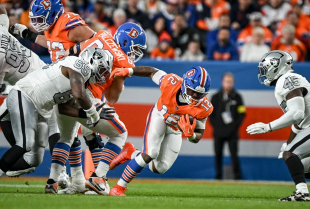 RJ Harvey (12) of the Denver Broncos runs as Alex...