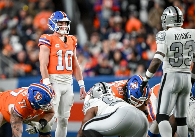 Bo Nix (10) of the Denver Broncos smirks as Jamal Adams (33) of the Las Vegas Raiders jaws with him while Nix attempts a failed hard count during the second quarter at Empower Field at Mile High Stadium on Thursday, Nov. 6, 2025. (Photo by AAron Ontiveroz/The Denver Post)