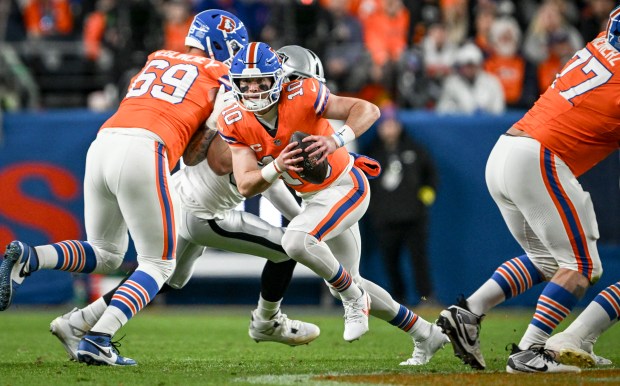 Bo Nix (10) of the Denver Broncos breaks pocket against...