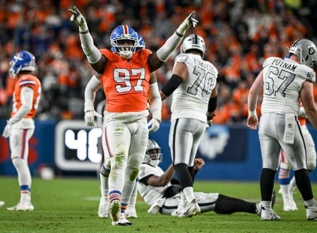 Malcolm Roach (97) of the Denver Broncos celebrates sacking Geno Smith (7) of the Las Vegas Raiders during the second quarter at Empower Field at Mile High Stadium on Thursday, Nov. 6, 2025. (Photo by AAron Ontiveroz/The Denver Post)
