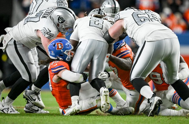 Alex Singleton (49) of the Denver Broncos wraps up Ashton Jeanty (2) of the Las Vegas Raiders during the second quarter at Empower Field at Mile High Stadium on Thursday, Nov. 6, 2025. (Photo by AAron Ontiveroz/The Denver Post)