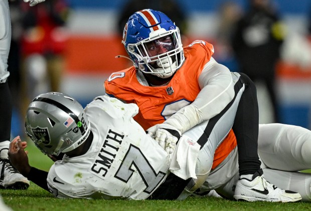 Jonathon Cooper (0) of the Denver Broncos lies on Geno...