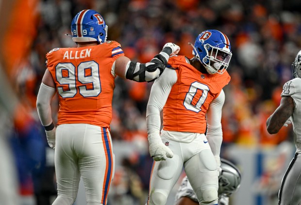 Jonathon Cooper (0) of the Denver Broncos celebrates with Zach...