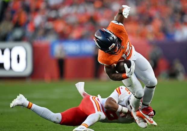 RJ Harvey (12) of the Denver Broncos, right, adds extra yards after making a catch against the Kansas City Chiefs at Empower Field at Mile High on Nov. 16, 2025. (Photo by RJ Sangosti/The Denver Post)