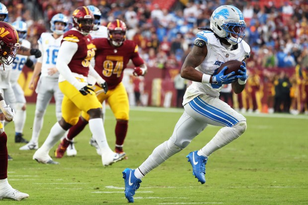 Detroit Lions running back Jahmyr Gibbs (0) runs with the...