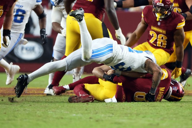 Detroit Lions safety Brian Branch (32) takes down Washington Commanders...