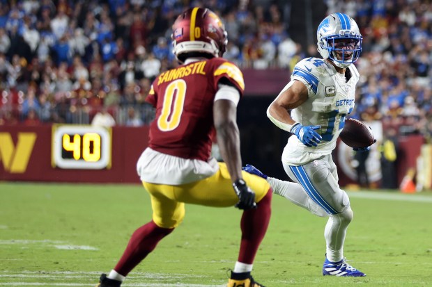 Detroit Lions wide receiver Amon-Ra St. Brown (14) runs with...