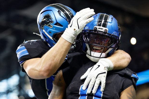 Detroit Lions running back Jahmyr Gibbs, right, is congratulated by...